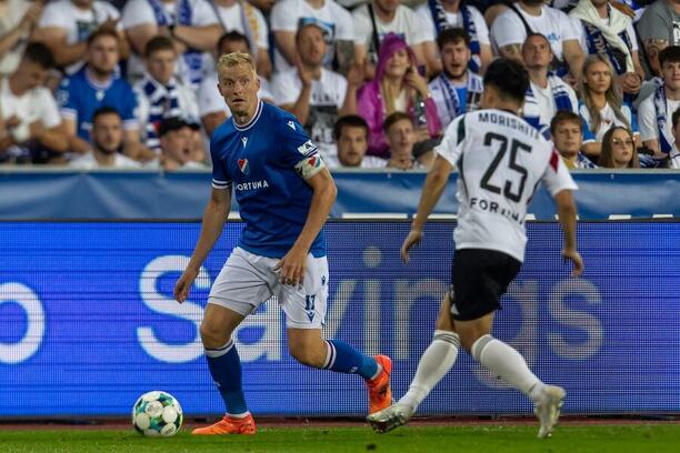 2. předkolo Evropské ligy 2025/26: Na fotce Michal Frydrych z Baníku (vlevo) a Rjoja Morišita hájící barvy Legie Varšava